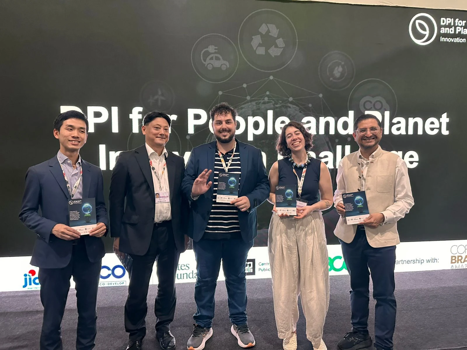 The five global winners of the DPI for People and Planet Innovation Challenge 2025 receiving their award at the DPI4PP ceremony held during COP30 in Belém, Brazil — Trust Carbon founder Brayon Pieske center